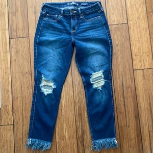 CUTE! Low Rise Super Skinny Crop. Distressed at knees and raw hem. Size 9.